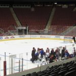 A group of Arizona Coyotes players gather and listen to assistant coach Jim Playfair explain a drill during the preseason at Gila River Arena on Sept. 23, 2016. (Photo by Matt Layman/Cronkite News)