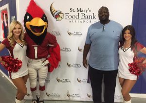 Jerome Daniels, Big Red and two Cardinals cheerleaders kicked off the holiday food drive. (Photo by Blair McElroy)