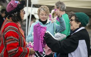 Joanie Pinkney gives out homemade pink hats at an activist’s gathering in Tucson, Arizona, on the day of President Donald Trump’s inauguration. (Photo by Johanna Huckeba/Cronkite News)