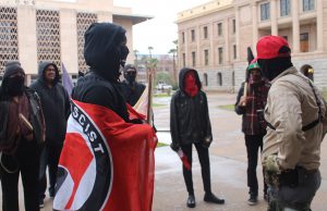 An anti-Trump protester (left) and a Trump supporter face off at the Arizona Capitol. (Photo by Ethan Millman/Cronkite News)