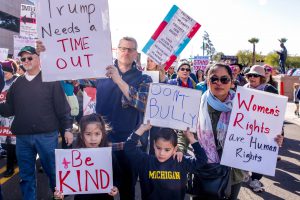 A family marches together at a women’s rights rally in Phoenix, conducted in cities and towns across Arizona in support of the Women’s March on Washington. (Photo by Saeed Alshamisi/Cronkite News)