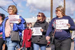 Three friends advocate for clean air and water and a stop to racism and misogyny during a Phoenix march in solidarity with the Women’s March on Washington. (Photo by Saeed Alshamisi/Cronkite News)