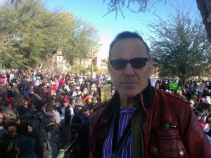 World traveler and photographer Brent Bishop, 60, walked in the Phoenix march to support his daughter, who walked in the Washington, D.C. march. (Photo by Saundra Wilson/Cronkite News)