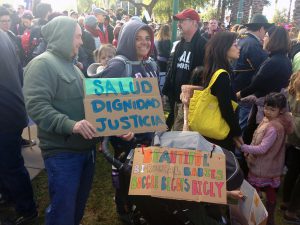 Gloria Montaño, 38, and Seean Greene, 45, celebrate their biracial family at the Phoenix women’s march. (Photo by Saundra Wilson/Cronkite News)