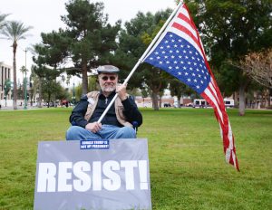 Maricopa resident Dennis Howerton, 67, said he has friends in the LGBT community and in communities of color who fear what will happen during the Trump administration. Howerton joined the President Trump inauguration protest in front of the Arizona State Capitol on Friday, Jan. 20, 2017. (Photo by Ryan Santistevan/Cronkite News)