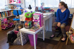 Cora Childress (left) and Caitlin Childress use Buzzies. Their mother said they both have anxiety.(Photo by Megan Bridgeman/ Cronkite News)