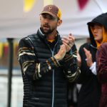 Michael Phelps encourages swimmers on the deck of Mona Plummer Aquatic Center on Friday, January 20, 2017. (Photo by Blake Benard/Cronkite News)