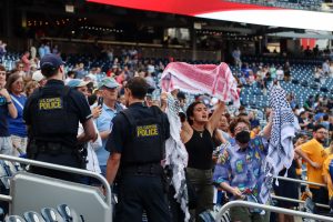 Capitol Police officers begin to escort pro-Palestinian protesters out of the Congressional Baseball Game at Nationals Park in Washington, D.C., on June 12, 2024. (Photo by Morgan Kubasko/Cronkite News)